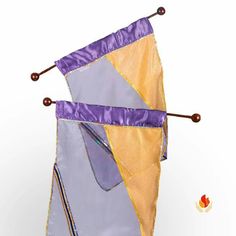 a purple and yellow kite is hanging upside down