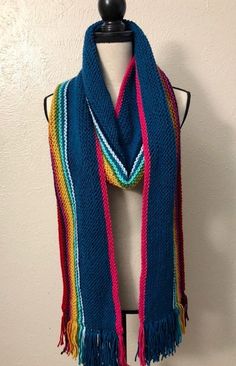 "MADE TO ORDER. TAKES 4-6 WEEKS TO COMPLETE. If you need it sooner, feel free to contact me. Hand-knit scarf inspired by the one worn by the Thirteenth Doctor on \"Doctor Who.\" Excellent for cosplay or everyday wear. Made from a soft, plush acrylic yarn. Approximately 7in (18cm) wide and 8 ft (2.4m) long. Can be custom made in any length--send me a convo!" Doctor Who Outfits, Thirteenth Doctor, Doctor Who Cosplay, Hand Knit Scarf, Rainbow Stripes, Dallas Tx, Knit Scarf, Acrylic Yarn, Doctor Who