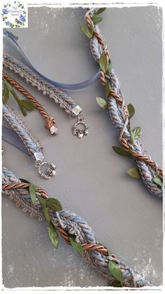 the necklaces are decorated with flowers and leaves on it's sides, along with other jewelry pieces