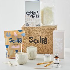 an assortment of crafting supplies sitting on top of a white table next to each other