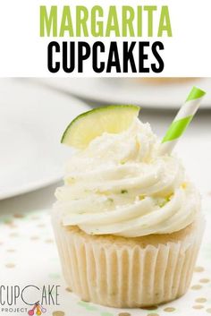 a cupcake with white frosting and a lime slice on top