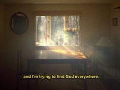 a table and chair in front of a window with the words and i'm trying to find god everywhere