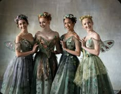 four women dressed in fairy costumes posing for the camera