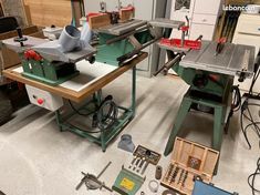 several tools are sitting on the floor next to each other in a room that has many different types of workbench