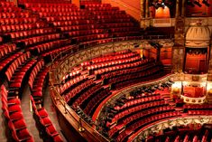 an auditorium filled with red seats and lights