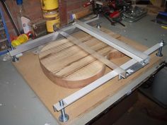 a table that has some wood on it and tools in front of the table top