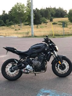 a black motorcycle parked in a parking lot