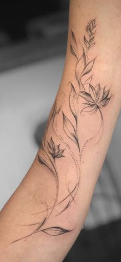 a flower tattoo on the arm