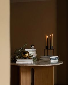 a table topped with books and candles on top of it