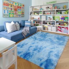 a living room filled with furniture and a blue rug