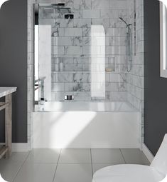 a bathroom with a white toilet sitting next to a walk in shower and a bathtub