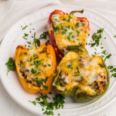 three stuffed bell peppers on a white plate