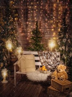 a wooden bench sitting on top of a wooden floor next to a forest filled with christmas trees