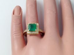 A Dazzling 2.02 Carat Square Shape Genuine Natural Emerald Is Securely prong Set at The  Center Of A Solid 14K Yellow Gold Ring Accented With 0.41Carats Of Natural G/H Color, SI Clarity Round Diamonds To Create This Gorgeous Ring Ring Size: 6.75 ( Free Ring Sizing +-2 Sizes) SPECIFICATIONS   Metal : 14k Yellow Gold Emerald Weight:  2.02 CT (~7.5mm) Emerald Shape:  Square Emerald Clarity:  SI Emerald Color:  Green  Total Diamond Weight:  0.41 Carat Diamond Shape:   Round Diamonds  Diamond Clarity Emerald And Diamond Ring, Emerald Color, Yellow Gold Engagement, Yellow Gold Engagement Rings, Emerald Gemstone, Natural Emerald, Gold Engagement Rings, Emerald Ring, Yellow Gold Rings