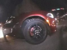 a blurry photo of a red motorcycle parked on the side of the road at night