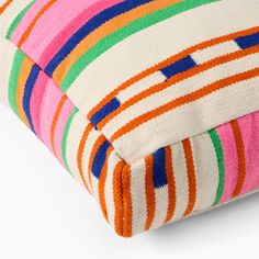 multicolored striped pillow on white background