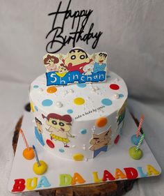 a birthday cake is decorated with cartoon characters and the words happy birthday written on it