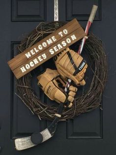 a hockey wreath on the front door of a house with gloves and an ice hockey stick