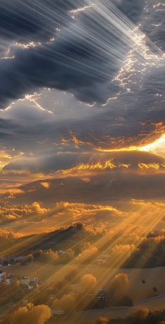 the sun shines brightly through clouds in this artistic photo taken from an airplane window