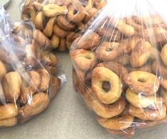 two bags filled with doughnuts sitting on top of a counter next to each other