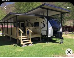 an rv parked in the grass with stairs leading up to it and a porch on one side