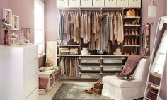 an organized closet is shown with clothes and shoes on the shelves, along with a white chair