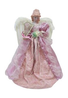 an angel figurine holding a harp and wearing a pink dress with white wings