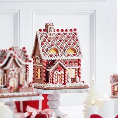 a gingerbread house is displayed on a table