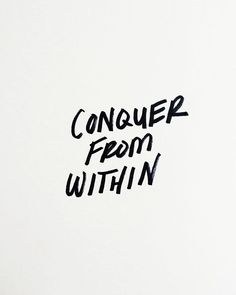 the words conquer from within written in black ink