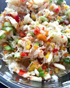 a bowl filled with rice and vegetables on top of a table