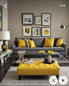 a gray and yellow living room with pictures on the wall, coffee table and ottoman