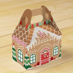 a paper bag with a gingerbread house on it