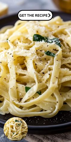 a black plate topped with pasta and parmesan cheese