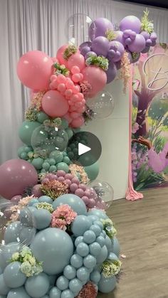 balloons and flowers are arranged in the shape of a pyramid