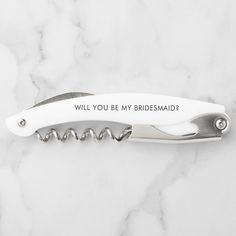 a white pocket knife with the word 11 11 on it's side and a corkscrew in the middle