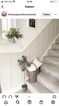 the stairs in this house have been painted white and are decorated with wicker baskets