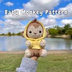 a person holding a stuffed animal in their hand with the words baby monkey pattern on it