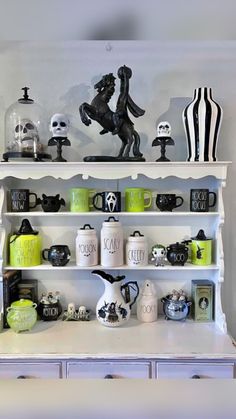 a white shelf filled with lots of halloween decorations