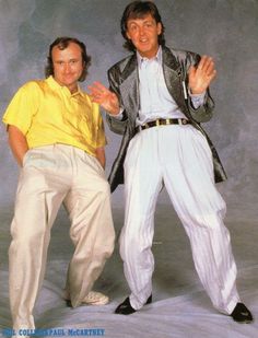 two men in white pants and yellow shirt posing for a photo with their hands together