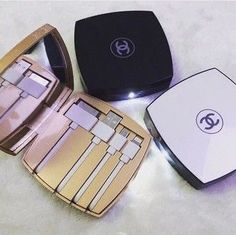 three different types of makeup sitting on top of a white table next to each other