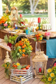 an outdoor table is decorated with flowers and candles