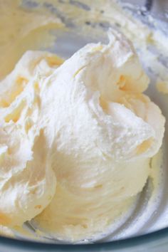 a bowl filled with whipped cream sitting on top of a table