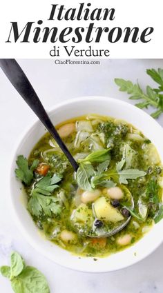 a bowl of soup with broccoli, beans and spinach on the side