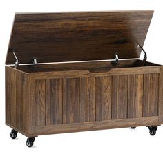 a large wooden chest with wheels on it