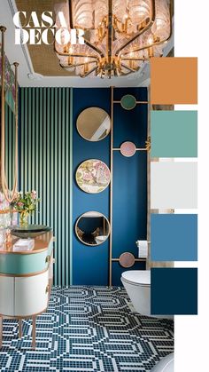 a bathroom with blue and green walls, gold accents and chandelier above the toilet