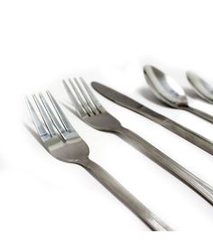 a set of five forks and spoons on a white surface