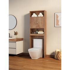 a bathroom with a toilet, cabinet and mirror on the wall next to wood flooring