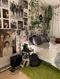 a bed room with a neatly made bed and lots of pictures on the wall