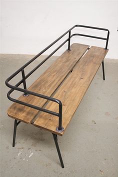 a wooden bench sitting on top of a metal frame