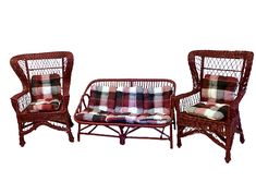 two wicker chairs and a couch with plaid cushions